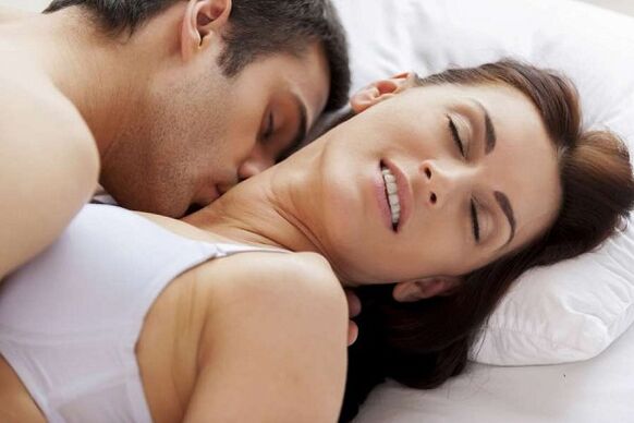 Homme excité et femme au lit
